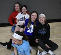 students sitting in gymnasium