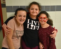 three students smiling