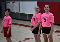 three students wearing dodgeball shirts