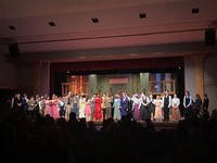 high school theatre guild cast and crew on stage