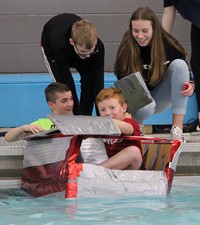 students sitting in boat