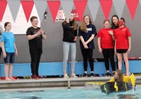 student paddling in boat from start