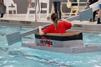 student paddling back to start in boat