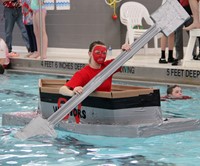 closer shot of student paddling boat