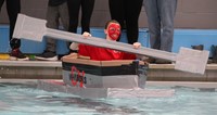 medium shot of student paddling boat