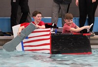 two students paddling boat