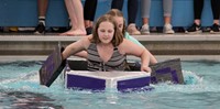 two students paddling boat