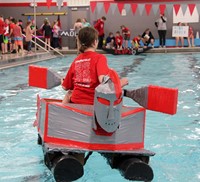 another image of student paddling boat back to start