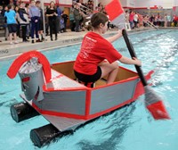 student paddling boat back to start