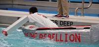 student paddling back to start