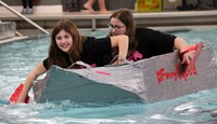 two students paddling boat