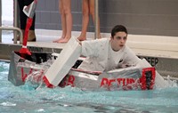 one student paddling