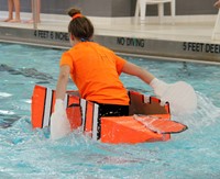 student paddling back to start