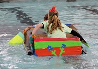 two students paddling back to start