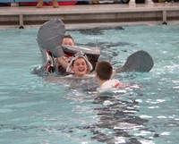 students laughing with sunken boat