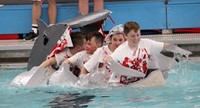 students paddling in boat