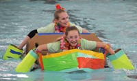 two students paddling boat