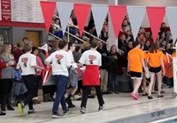 teams of students carrying boats