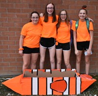 students standing next to boat