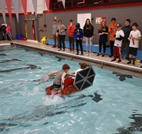 student paddling back to start