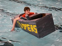 student paddling in boat