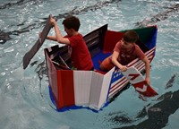 two students paddling in boat