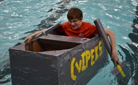 student paddling in boat