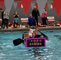 students paddling in boat