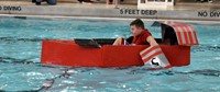 student paddling in boat