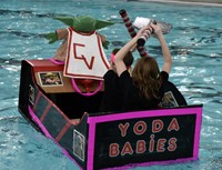 students paddling in boat