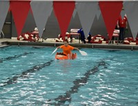 wide shot of one student paddling in boat