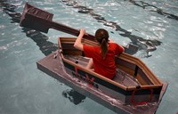 student paddling in boat