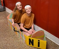 two students sitting in boat