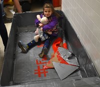 younger student sitting in boat