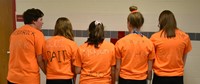 five student showing back of finding nemo themed shirts