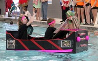 two students paddling in boat