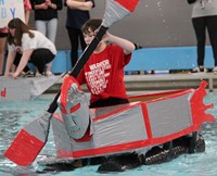 one student paddling in boat