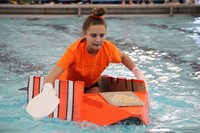 student paddling in boat