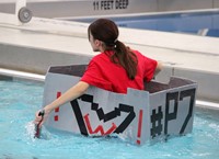 student paddling in boat back to start