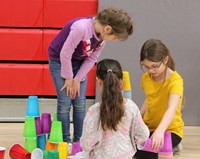 students building with cups