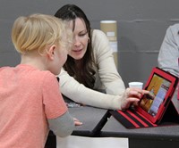 student and educator at steam night activity