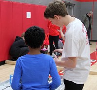 two students working with robots