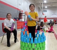 students building with cups