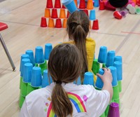 students building with cups