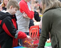 student and adult at steam night station