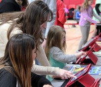 students and educators at steam night station