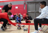 wide shot of students working with robotics