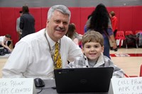 adult and child at coding station