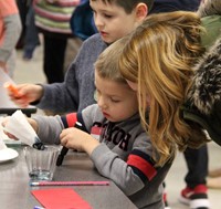 adult and child at steam night station