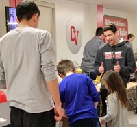 students watching rube goldberg machine